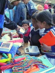 Distributing school supplies provided by LED in Peru